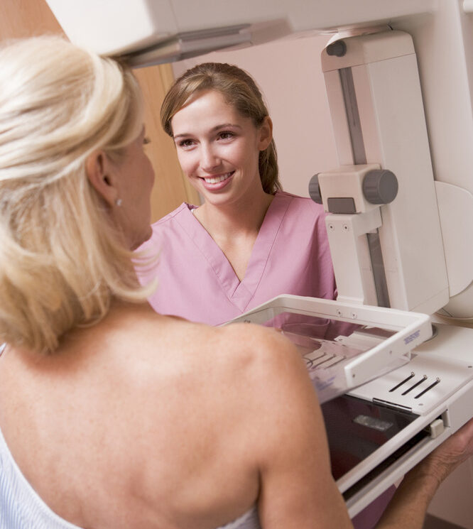 photo of care provider giving a patient a mammogram
