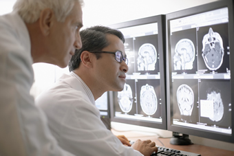 Two radiologists examining some scans