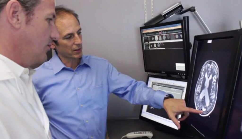 Doctors collaborate while reviewing a brain scan