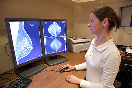 Radiology technician examines mammography test